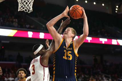 Nov 14, 2023; Los Angeles, California, USA; UC Irvine Anteaters center Bent Leuchten (15) shoots the ball against Southern California Trojans forward Vincent Iwuchukwu (3)  in the first half at Galen Center. Mandatory Credit: Kirby Lee-USA TODAY Sports