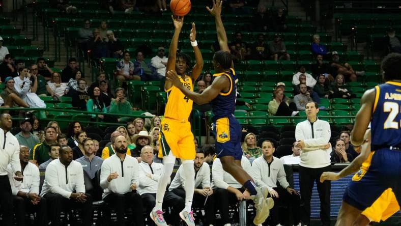 Nov 14, 2023; Waco, Texas, USA; Baylor Bears guard Ja'Kobe Walter (4) makes a three point shot against UMKC Kangaroos guard Jayson Petty (1) during the second half at Ferrell Center. Mandatory Credit: Chris Jones-USA TODAY Sports