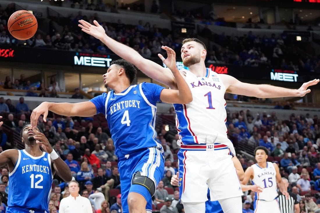 Nov 14, 2023; Chicago, Illinois, USA;  Kentucky Wildcats forward Tre Mitchell (4) defends Kansas Jayhawks center Hunter Dickinson (1) during the second half at United Center. Mandatory Credit: David Banks-USA TODAY Sports