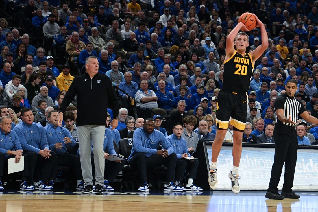 Nov 14, 2023; Omaha, Nebraska, USA; Iowa Hawkeyes forward Payton Sandfort (20) attempts a shot against the Creighton Bluejays in the first half at CHI Health Center Omaha. Mandatory Credit: Steven Branscombe-USA TODAY Sports