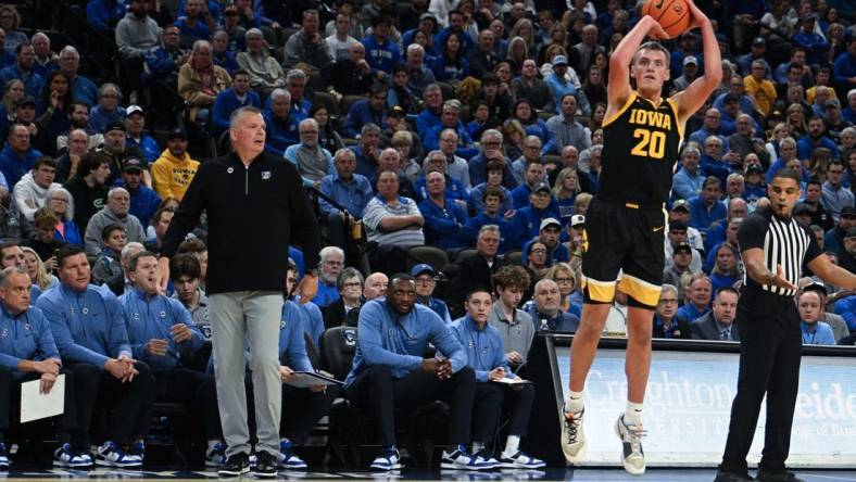 Nov 14, 2023; Omaha, Nebraska, USA; Iowa Hawkeyes forward Payton Sandfort (20) attempts a shot against the Creighton Bluejays in the first half at CHI Health Center Omaha. Mandatory Credit: Steven Branscombe-USA TODAY Sports