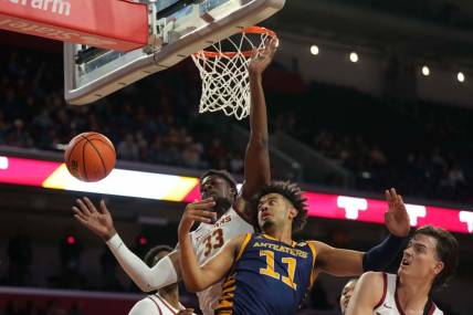 Nov 14, 2023; Los Angeles, California, USA; UC Irvine Anteaters forward Devin Tillis (11) battles for the ball with Southern California Trojans forward Kijani Wright (33) and forward Harrison Hornery (30) in the first half at Galen Center. Mandatory Credit: Kirby Lee-USA TODAY Sports