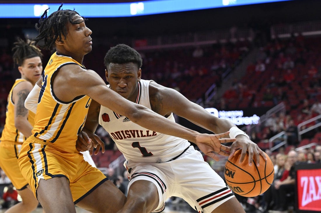 Nov 15, 2023; Louisville, Kentucky, USA; Coppin State Eagles guard Camaren Sparrow (23) pressures the dribble of Louisville Cardinals guard Curtis Williams (1) during the first half at KFC Yum! Center. Mandatory Credit: Jamie Rhodes-USA TODAY Sports