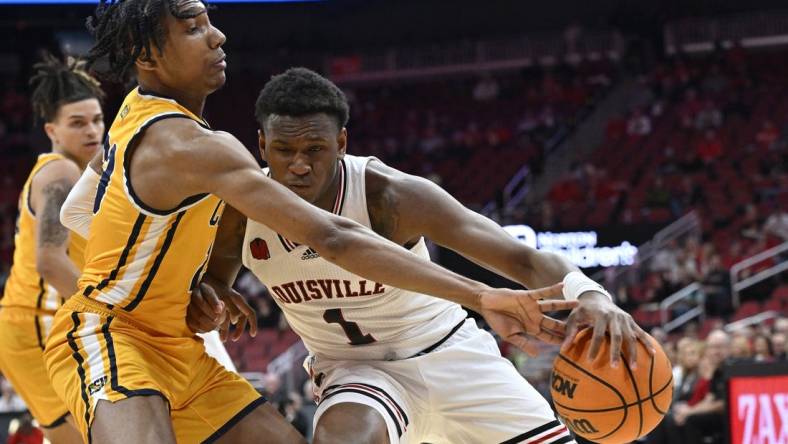 Nov 15, 2023; Louisville, Kentucky, USA; Coppin State Eagles guard Camaren Sparrow (23) pressures the dribble of Louisville Cardinals guard Curtis Williams (1) during the first half at KFC Yum! Center. Mandatory Credit: Jamie Rhodes-USA TODAY Sports