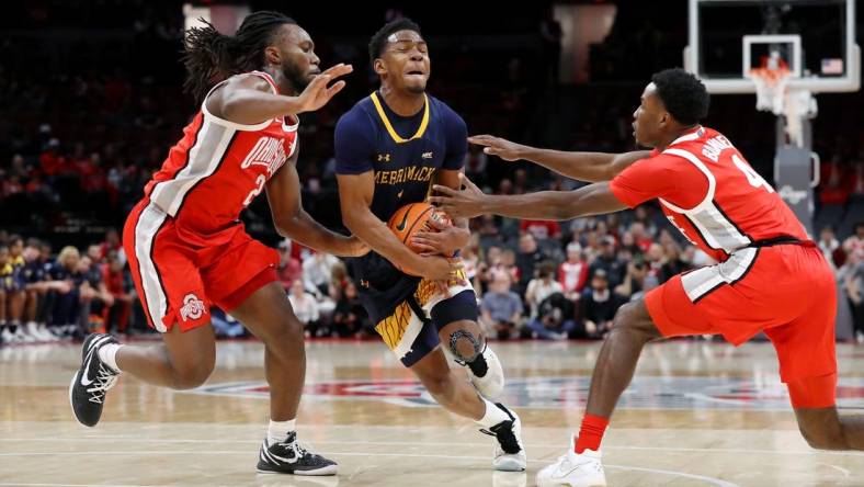 Nov 15, 2023; Columbus, Ohio, USA;  Merrimack College Warriors guard Jaylen Stinson (1) dribbles into the lane as Ohio State Buckeyes guard Bruce Thornton (left) and guard Dale Bonner (4) defend on the play at Value City Arena. Mandatory Credit: Joseph Maiorana-USA TODAY Sports