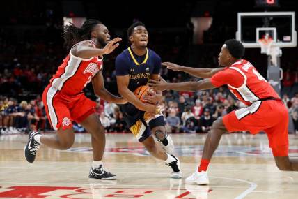 Nov 15, 2023; Columbus, Ohio, USA;  Merrimack College Warriors guard Jaylen Stinson (1) dribbles into the lane as Ohio State Buckeyes guard Bruce Thornton (left) and guard Dale Bonner (4) defend on the play at Value City Arena. Mandatory Credit: Joseph Maiorana-USA TODAY Sports