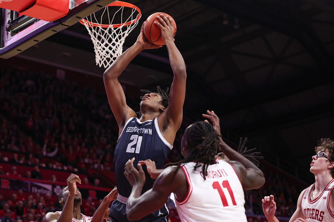 Nov 15, 2023; Piscataway, New Jersey, USA; Georgetown Hoyas center Ryan Mutombo (21) goes to the basket in front of Rutgers Scarlet Knights center Clifford Omoruyi (11) and guard Gavin Griffiths (10) during the first half at Jersey Mike