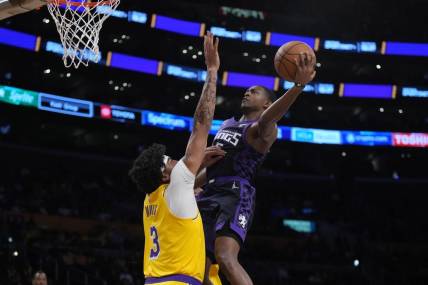 Nov 15, 2023; Los Angeles, California, USA; Sacramento Kings guard De'Aaron Fox (5) shoots the ball against Los Angeles Lakers forward Anthony Davis (3) in the first half at Crypto.com Arena. Mandatory Credit: Kirby Lee-USA TODAY Sports