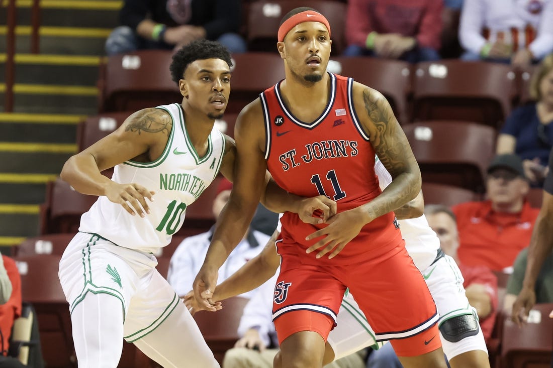 Nov 16, 2023; Charleston, South Carolina, USA; St. John's Red Storm center Joel Soriano (11) is defended by North Texas Mean Green forward Robert Allen (10) in the first half at TD Arena. Mandatory Credit: David Yeazell-USA TODAY Sports