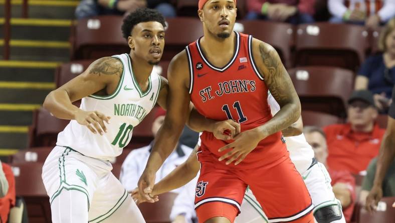 Nov 16, 2023; Charleston, South Carolina, USA; St. John's Red Storm center Joel Soriano (11) is defended by North Texas Mean Green forward Robert Allen (10) in the first half at TD Arena. Mandatory Credit: David Yeazell-USA TODAY Sports