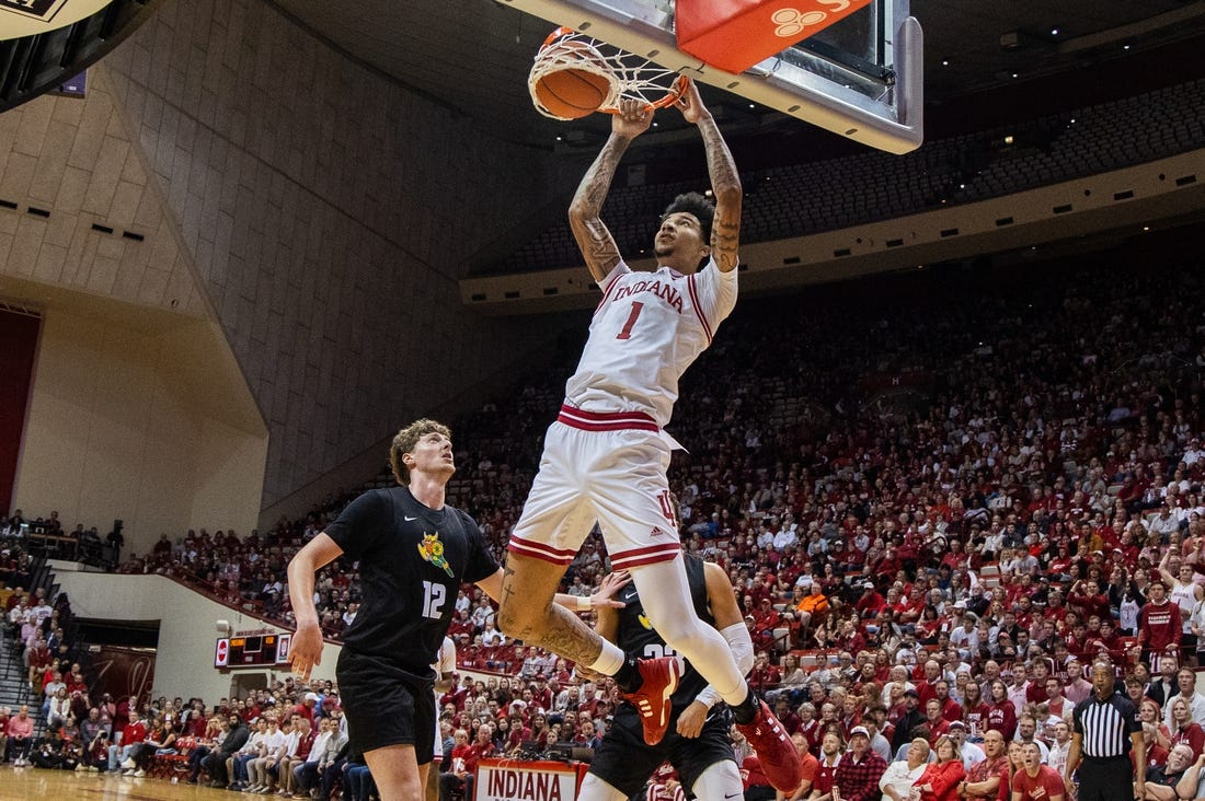 Nov 16, 2023; Bloomington, Indiana, USA; Indiana Hoosiers center Kel'el Ware (1) shoots the ball while Wright State Raiders center AJ Braun (12) defends in the first half at Simon Skjodt Assembly Hall. Mandatory Credit: Trevor Ruszkowski-USA TODAY Sports