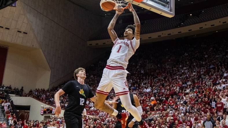 Nov 16, 2023; Bloomington, Indiana, USA; Indiana Hoosiers center Kel'el Ware (1) shoots the ball while Wright State Raiders center AJ Braun (12) defends in the first half at Simon Skjodt Assembly Hall. Mandatory Credit: Trevor Ruszkowski-USA TODAY Sports