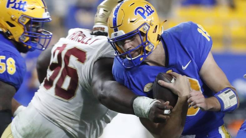 Nov 16, 2023; Pittsburgh, Pennsylvania, USA; Pittsburgh Panthers quarterback Nate Yarnell (19) carries the ball against Boston College Eagles defensive tackle Cam Horsley (96) during the second quarter at Acrisure Stadium. Mandatory Credit: Charles LeClaire-USA TODAY Sports