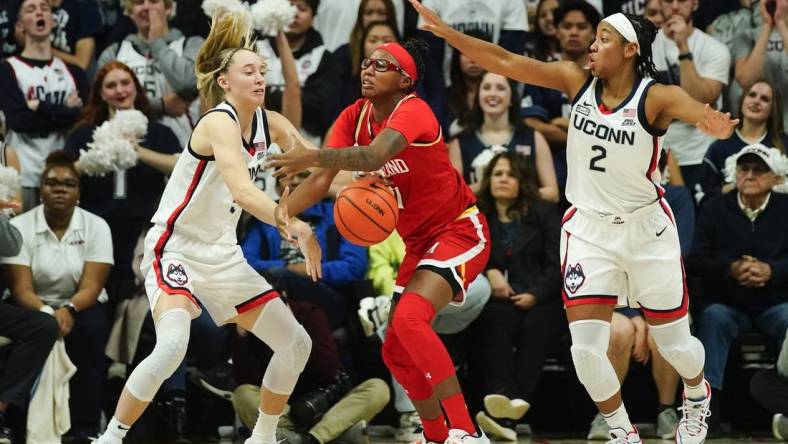 Nov 16, 2023; Storrs, Connecticut, USA; Connecticut Huskies guard Paige Bueckers (5) and Maryland Terrapins guard Jakia Brown-Turner (11) battle for a loose ball during the second half at Harry A. Gampel Pavilion. Mandatory Credit: Gregory Fisher-USA TODAY Sports