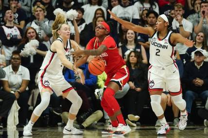 Nov 16, 2023; Storrs, Connecticut, USA; Connecticut Huskies guard Paige Bueckers (5) and Maryland Terrapins guard Jakia Brown-Turner (11) battle for a loose ball during the second half at Harry A. Gampel Pavilion. Mandatory Credit: Gregory Fisher-USA TODAY Sports