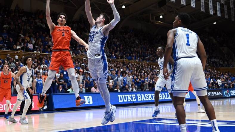 Nov 17, 2023; Durham, North Carolina, USA; Bucknell Bison forward Brady Muller (3) shoots over Duke Blue Devils center Kyle Filipowski(30) during the first half at Cameron Indoor Stadium. Mandatory Credit: Rob Kinnan-USA TODAY Sports