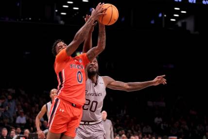Nov 17, 2023; Brookyln, NY, USA; Auburn Tigers guard K.D. Johnson (0) grabs a rebound against St. Bonaventure Bonnies center Noel Brown (20) during the first half at Barclays Center. Mandatory Credit: Brad Penner-USA TODAY Sports