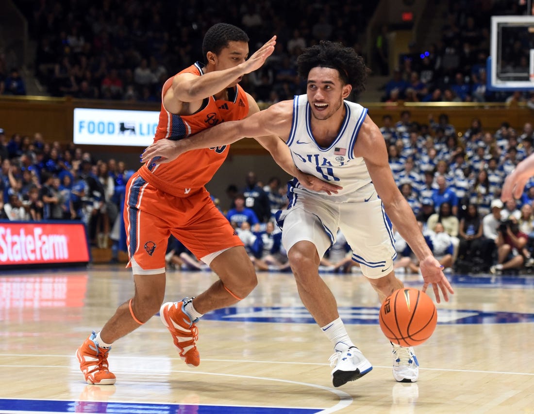 Nov 17, 2023; Durham, North Carolina, USA; Duke Blue Devils guard Jared McCain (0) drives to the basket as Bucknell Bison guard Brandon McCreesh (10) defends during the second half at Cameron Indoor Stadium. Mandatory Credit: Rob Kinnan-USA TODAY Sports