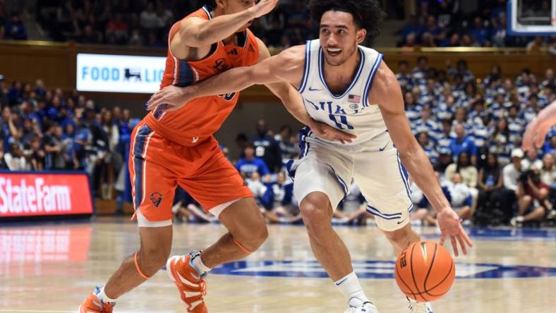 Nov 17, 2023; Durham, North Carolina, USA; Duke Blue Devils guard Jared McCain (0) drives to the basket as Bucknell Bison guard Brandon McCreesh (10) defends during the second half at Cameron Indoor Stadium. Mandatory Credit: Rob Kinnan-USA TODAY Sports