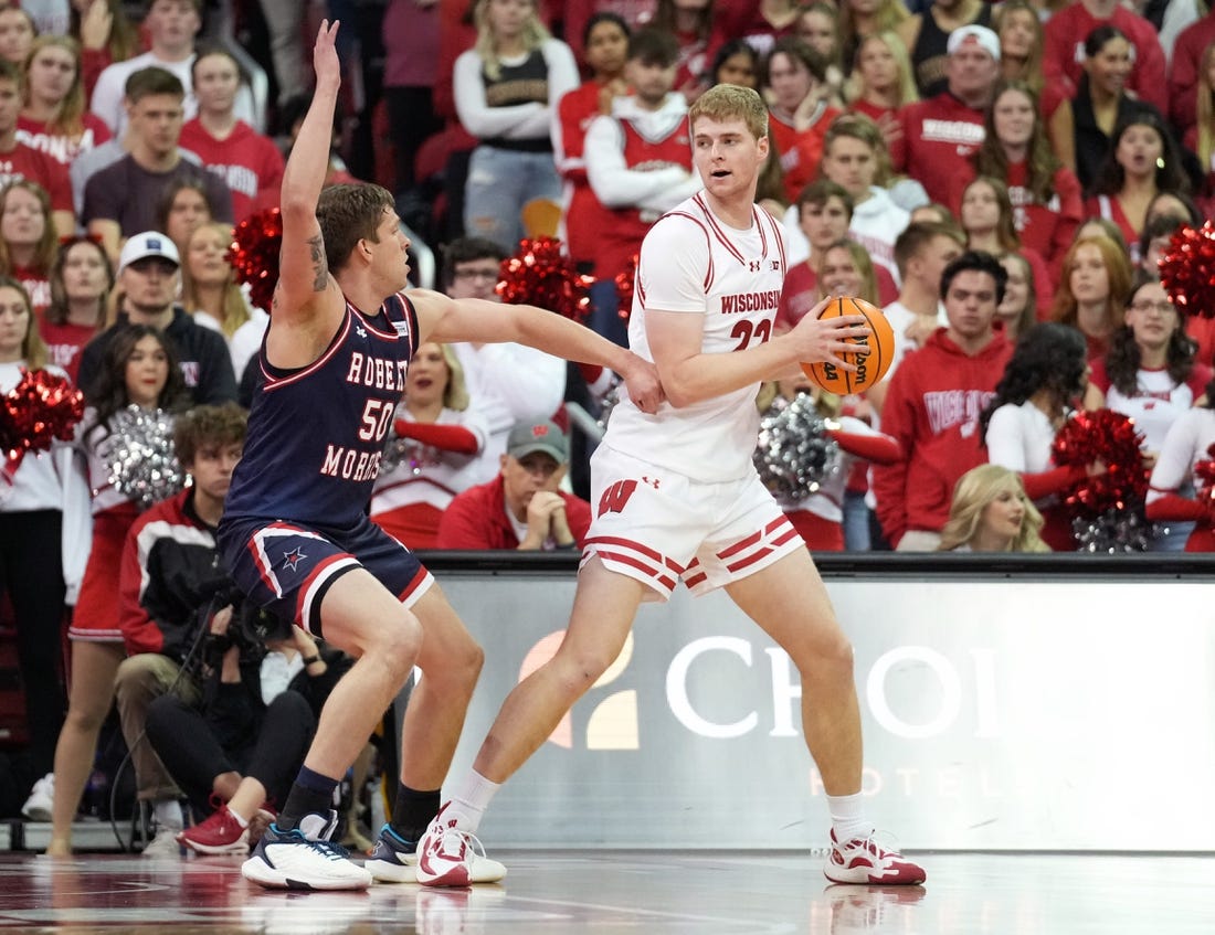 Nov 17, 2023; Madison, Wisconsin, USA; Wisconsin Badgers forward Steven Crowl (22) looks to the basket under coverage by Robert Morris Colonials forward Trey James (50) during the first half at the Kohl Center. Mandatory Credit: Kayla Wolf-USA TODAY Sports