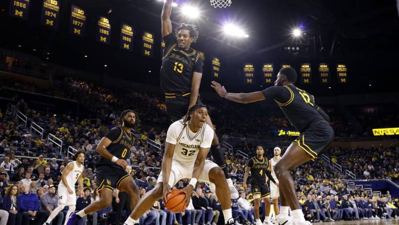 Nov 17, 2023; Ann Arbor, Michigan, USA;  Michigan Wolverines forward Tarris Reed Jr. (32) is defended by Long Beach State 49ers center Chayce Polynice (13) in the first half at Crisler Center. Mandatory Credit: Rick Osentoski-USA TODAY Sports