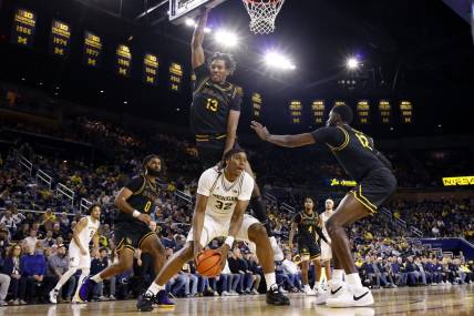 Nov 17, 2023; Ann Arbor, Michigan, USA;  Michigan Wolverines forward Tarris Reed Jr. (32) is defended by Long Beach State 49ers center Chayce Polynice (13) in the first half at Crisler Center. Mandatory Credit: Rick Osentoski-USA TODAY Sports
