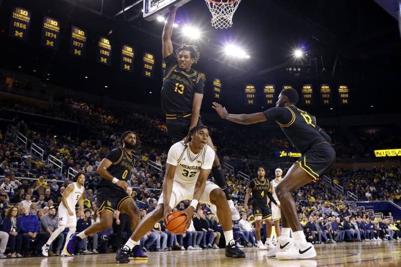 Nov 17, 2023; Ann Arbor, Michigan, USA;  Michigan Wolverines forward Tarris Reed Jr. (32) is defended by Long Beach State 49ers center Chayce Polynice (13) in the first half at Crisler Center. Mandatory Credit: Rick Osentoski-USA TODAY Sports