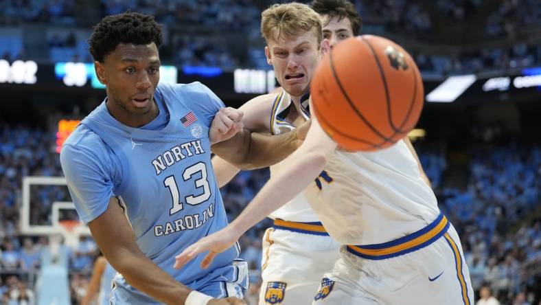 Nov 17, 2023; Chapel Hill, North Carolina, USA; North Carolina Tar Heels forward Jalen Washington (13) and UC Riverside Highlanders forward Wil Tattersall (14) fight for the ball in the first half at Dean E. Smith Center. Mandatory Credit: Bob Donnan-USA TODAY Sports