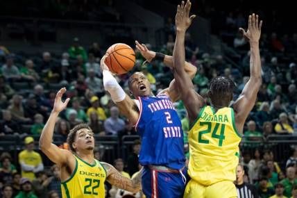 Oregon center Mahamadou Diawara fouls Tennessee State guard Christian Brown as the Oregon Ducks host Tennessee State Friday, Nov. 17, 2023, at Matthew Knight Arena in Eugene, Ore.