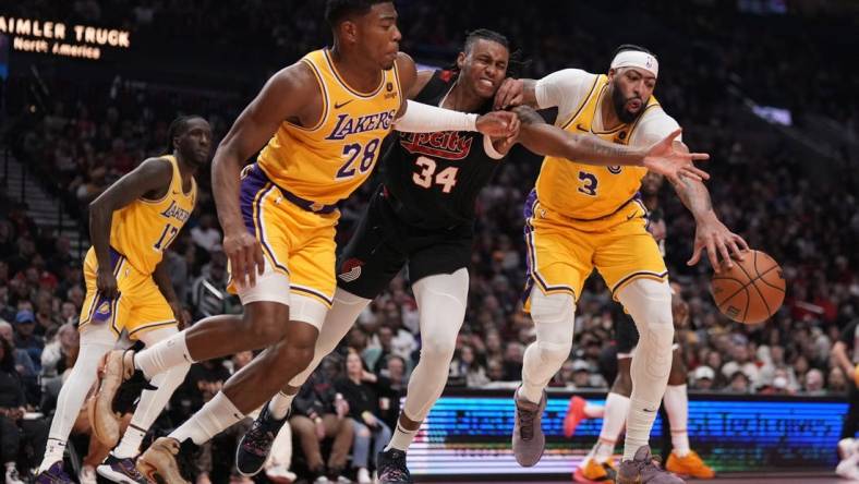 Nov 17, 2023; Portland, Oregon, USA; Portland Trail Blazers forward Jabari Walker (34) and Los Angeles Lakers power forward Rui Hachimura (28) and Anthony Davis (3) go after a loose ball during the first half at Moda Center. Mandatory Credit: Soobum Im-USA TODAY Sports