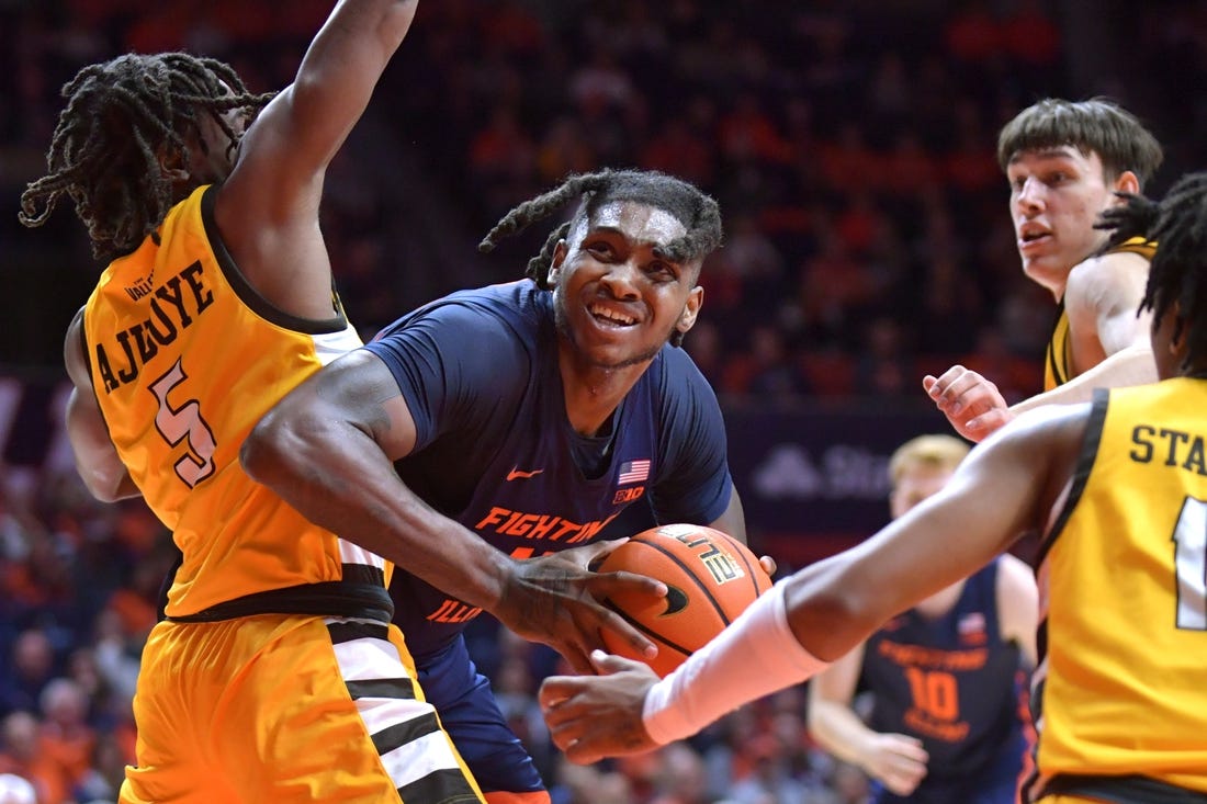 Nov 17, 2023; Champaign, Illinois, USA; Illinois Fighting Illini forward Dain Dainja (42) moves around Valparaiso Beacons forward Ola Ajiboye (5) as he drives to the basket during the first half at State Farm Center. Mandatory Credit: Ron Johnson-USA TODAY Sports