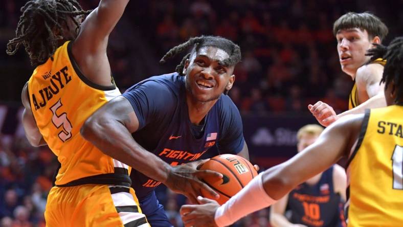 Nov 17, 2023; Champaign, Illinois, USA; Illinois Fighting Illini forward Dain Dainja (42) moves around Valparaiso Beacons forward Ola Ajiboye (5) as he drives to the basket during the first half at State Farm Center. Mandatory Credit: Ron Johnson-USA TODAY Sports