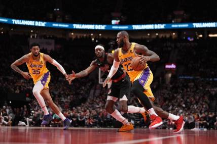 Nov 17, 2023; Portland, Oregon, USA; Los Angeles Lakers small forward LeBron James (23) dribbles the ball while defended by Portland Trail Blazers small forward Jerami Grant (9) during the second half at Moda Center. Mandatory Credit: Soobum Im-USA TODAY Sports