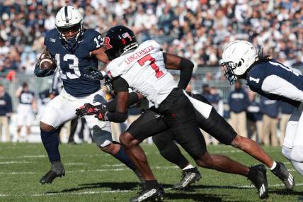 Nov 18, 2023; University Park, Pennsylvania, USA; Penn State Nittany Lions running back Kaytron Allen (13) carries the ball as Rutgers Scarlet Knights defensive back Robert Longerbeam (7) pursues during the first half at Beaver Stadium. Mandatory Credit: Vincent Carchietta-USA TODAY Sports
