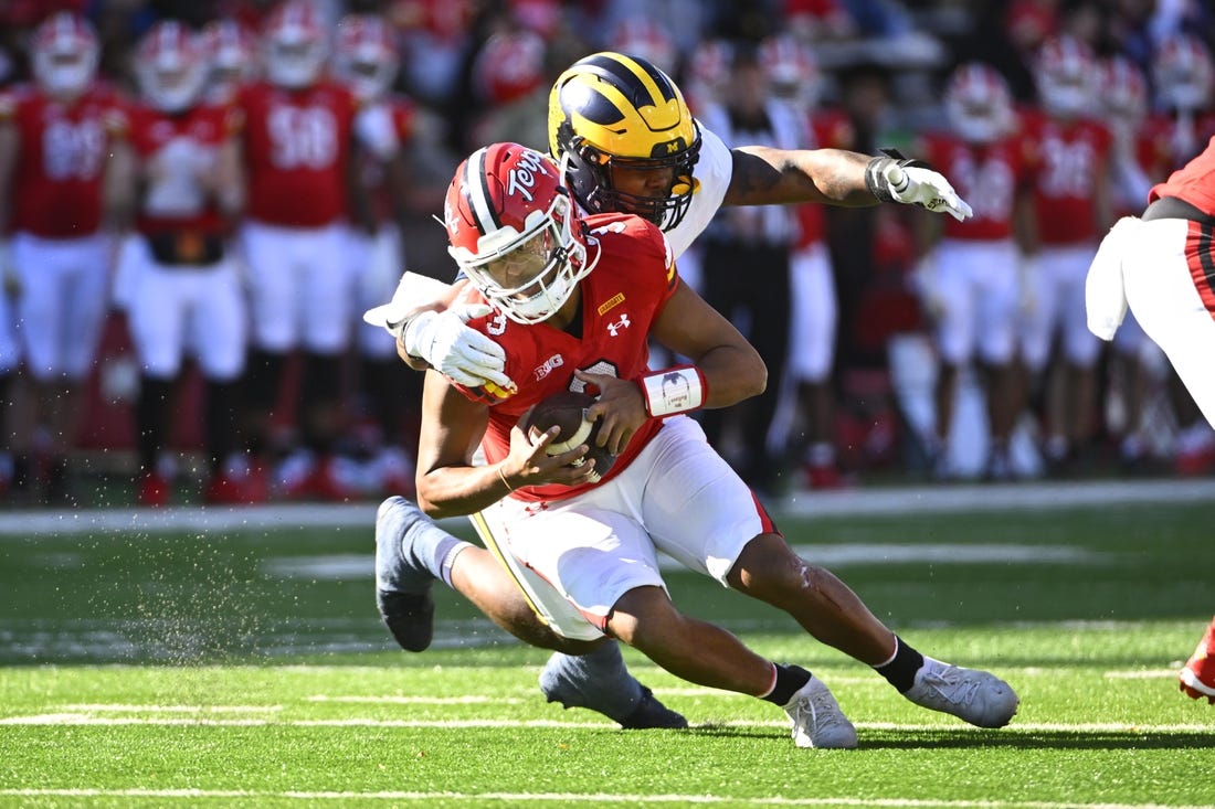 Nov 18, 2023; College Park, Maryland, USA; Michigan Wolverines defensive end Jaylen Harrell (32) sacks Maryland Terrapins quarterback Taulia Tagovailoa (3) during the first half at SECU Stadium. Mandatory Credit: Brad Mills-USA TODAY Sports