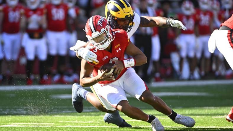 Nov 18, 2023; College Park, Maryland, USA; Michigan Wolverines defensive end Jaylen Harrell (32) sacks Maryland Terrapins quarterback Taulia Tagovailoa (3) during the first half at SECU Stadium. Mandatory Credit: Brad Mills-USA TODAY Sports