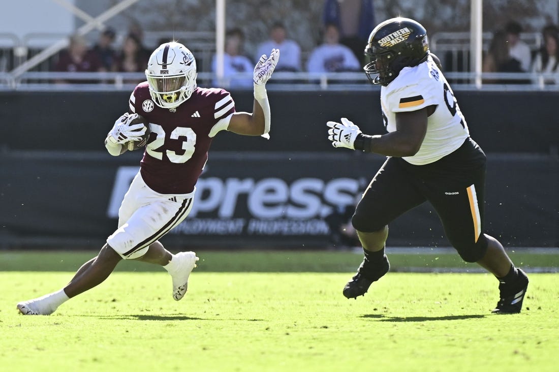 Nov 18, 2023; Starkville, Mississippi, USA; Mississippi State Bulldogs running back Seth Davis (23) runs the ball while defended by Southern Miss Golden Eagles defensive tackle Josh Ratcliff (93) during the second quarter at Davis Wade Stadium at Scott Field. Mandatory Credit: Matt Bush-USA TODAY Sports