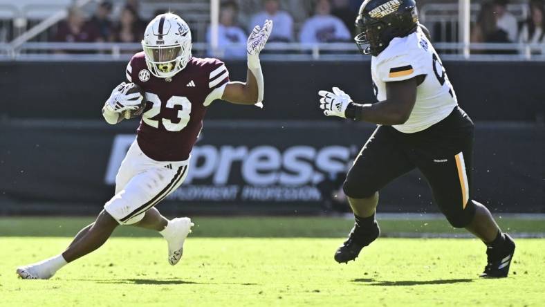 Nov 18, 2023; Starkville, Mississippi, USA; Mississippi State Bulldogs running back Seth Davis (23) runs the ball while defended by Southern Miss Golden Eagles defensive tackle Josh Ratcliff (93) during the second quarter at Davis Wade Stadium at Scott Field. Mandatory Credit: Matt Bush-USA TODAY Sports