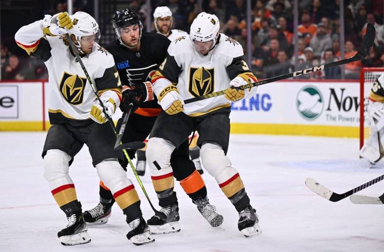 Nov 18, 2023; Philadelphia, Pennsylvania, USA; Vegas Golden Knights defenseman Brayden McNabb (3) and center William Karlsson (71) battle for the puck with Philadelphia Flyers right wing Tyson Foerster (71) in the second period at Wells Fargo Center. Mandatory Credit: Kyle Ross-USA TODAY Sports