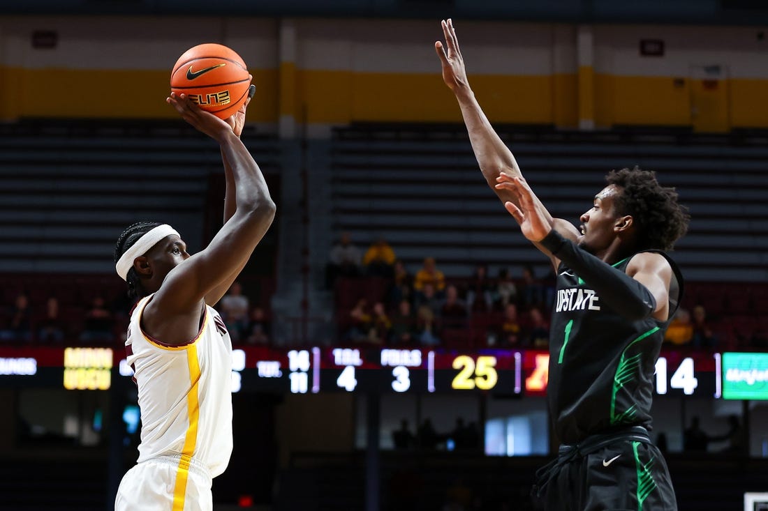 Nov 18, 2023; Minneapolis, Minnesota, USA; Minnesota Golden Gophers forward Isaiah Ihnen (5) shoots while USC Upstate Spartans guard Nick Alves (1) defends during the first half at Williams Arena. Mandatory Credit: Matt Krohn-USA TODAY Sports