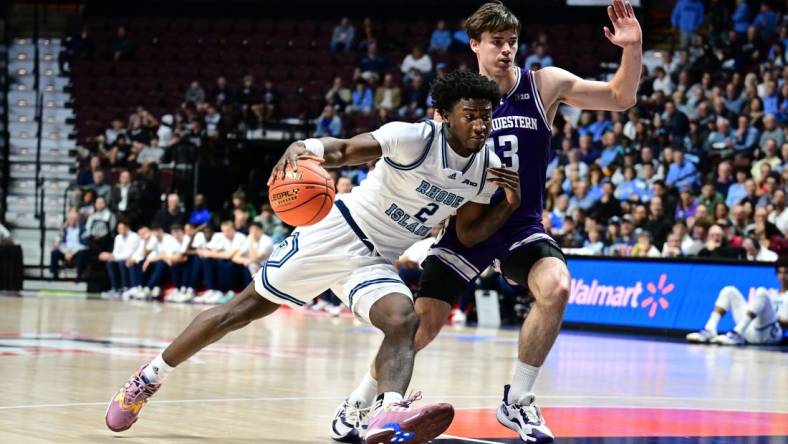 Nov 18, 2023; Uncasville, Connecticut, USA; Rhode Island Rams guard Jaden House (2) dribbles the ball around Northwestern Wildcats guard Brooks Barnhizer (13) during the first half at Mohegan Sun Arena. Mandatory Credit: Mark Smith-USA TODAY Sports