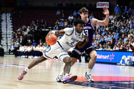 Nov 18, 2023; Uncasville, Connecticut, USA; Rhode Island Rams guard Jaden House (2) dribbles the ball around Northwestern Wildcats guard Brooks Barnhizer (13) during the first half at Mohegan Sun Arena. Mandatory Credit: Mark Smith-USA TODAY Sports