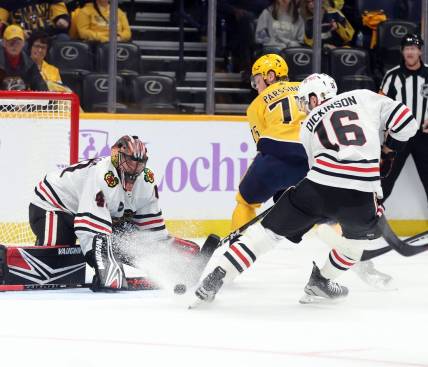 Nov 18, 2023; Nashville, Tennessee, USA;  Nashville Predators player Juuso Parssinen (75) shoots against Chicago Blackhawks players Arvid Soderblom (40) and player Jason Dickinson (16) during the first period of their game at Bridgestone Arena. Mandatory Credit: Alan Poizner-USA TODAY Sports