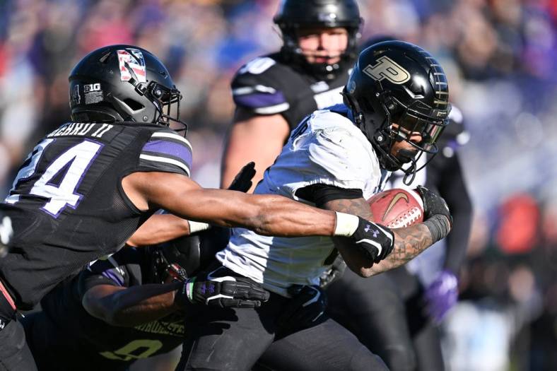 Nov 18, 2023; Evanston, Illinois, USA;  Purdue Boilermakers running back Tyrone Tracy Jr. (3) breaks a tackle by Northwestern Wildcats defensive back Rod Heard II (24) for a touchdown run in the third quarter at Ryan Field. Mandatory Credit: Jamie Sabau-USA TODAY Sports