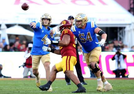 Nov 18, 2023; Los Angeles, California, USA; UCLA Bruins quarterback Ethan Garbers (4) throws during the second quarter against the USC Trojans at United Airlines Field at Los Angeles Memorial Coliseum. Mandatory Credit: Jason Parkhurst-USA TODAY Sports