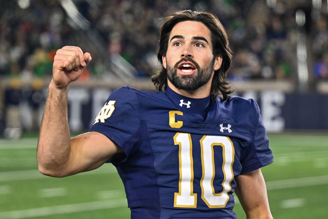 Nov 18, 2023; South Bend, Indiana, USA; Notre Dame Fighting Irish quarterback Sam Hartman (10) exhorts the crowd in the fourth quarter against the Wake Forest Demon Deacons at Notre Dame Stadium. Mandatory Credit: Matt Cashore-USA TODAY Sports