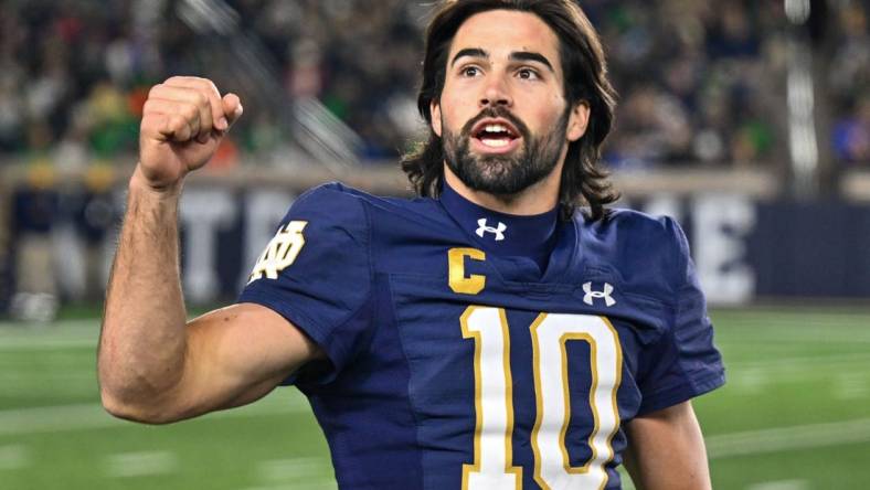 Nov 18, 2023; South Bend, Indiana, USA; Notre Dame Fighting Irish quarterback Sam Hartman (10) exhorts the crowd in the fourth quarter against the Wake Forest Demon Deacons at Notre Dame Stadium. Mandatory Credit: Matt Cashore-USA TODAY Sports