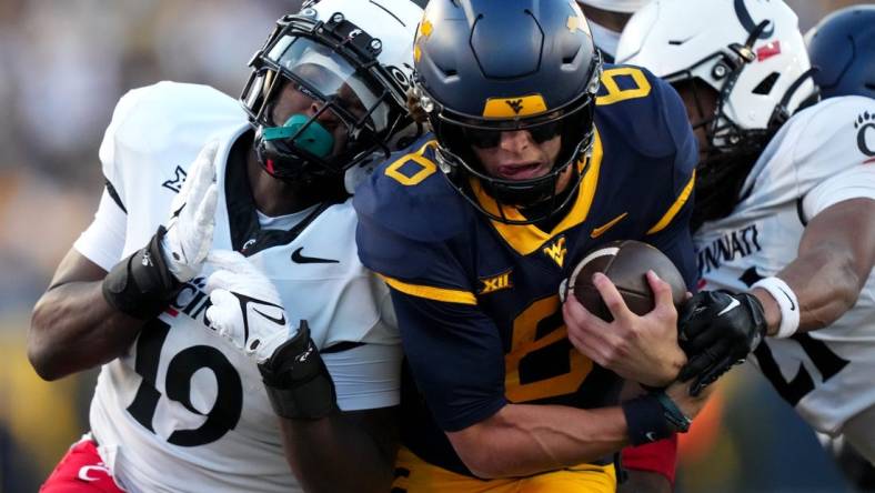 West Virginia Mountaineers quarterback Garrett Greene (6) carries the ball on a touchdown run in the third quarter during an NCAA college football game between the Cincinnati Bearcats and the West Virginia Mountaineers, Saturday, Nov. 18, 2023, at Milan Puskar Stadium in Morgantown, W. Va. The West Virginia Mountaineers won, 42-21.