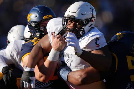 Nov 18, 2023; Morgantown, West Virginia, USA; Cincinnati Bearcats defensive lineman Dontay Corleone (2) is double-teamed on a pass rush against the West Virginia Mountaineers in the first quarter at Milan Puskar Stadium.  Mandatory Credit: Kareem Elgazzar-USA TODAY Sports