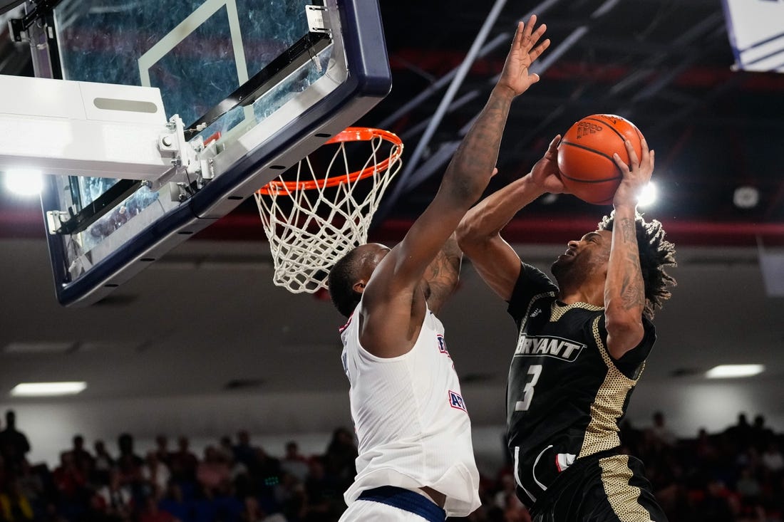 Nov 18, 2023; Boca Raton, Florida, USA;  Bryant University Bulldogs guard Sherif Gross-Bullock (3) shoots against Florida Atlantic Owls guard Johnell Davis (1) during the second half at Eleanor R. Baldwin Arena. Mandatory Credit: Rich Storry-USA TODAY Sports